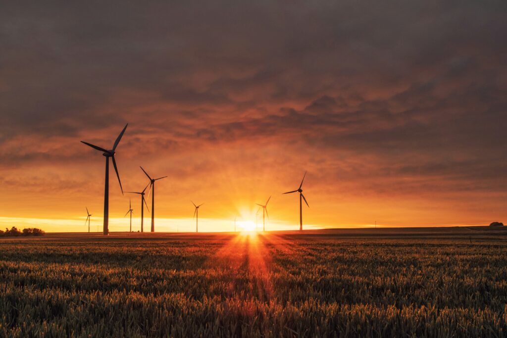 Wind turbines against a sunset