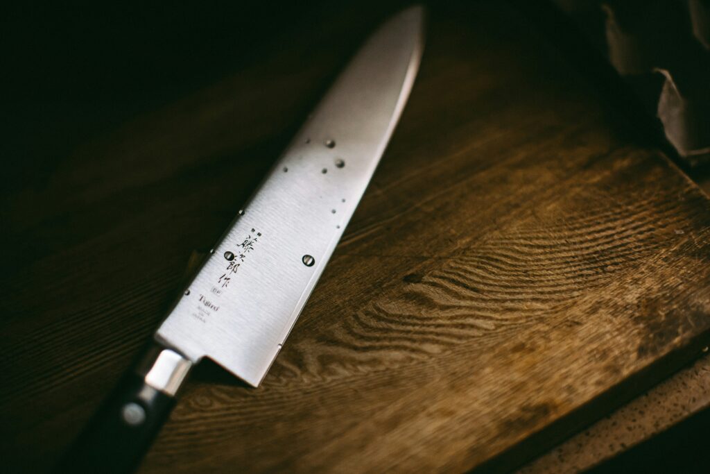 Wet knife sitting on a cutting board