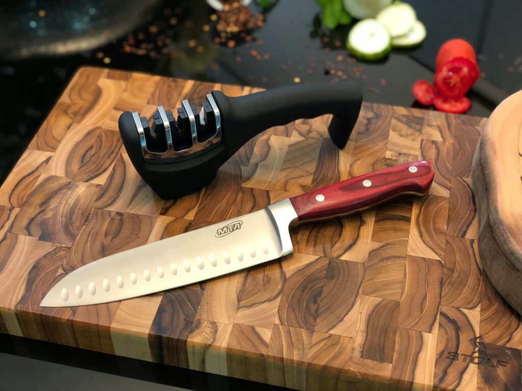 Knife sitting next to a sharpener